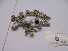 A silver charm bracelet, 70 grams.