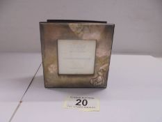 A wooden trinket box with hall marked silver top featuring a teddy bear.