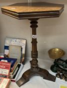 A dark wood wine table with hexagonal top