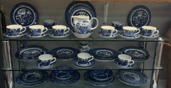 A blue & white willow pattern dinner set by Churchill & A quantity of other blue & white dinner