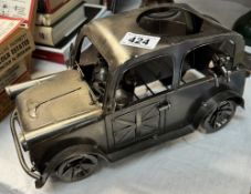 A novelty steel wine bottle holder in the shape of a London taxi