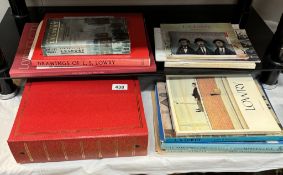 A collection of Lowry related books and an album of Lowry related postcards