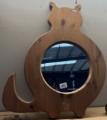 A large pine framed cat shaped mirror
