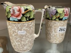 A pair of Winton floral jugs