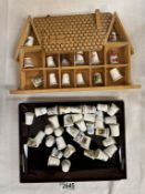 A quantity of porcelain thimbles & a small display shelf
