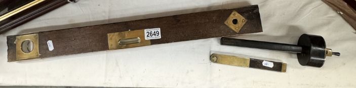 3 Pieces of wood and brass tools including A spirit level, carpenters depth marker etc