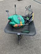A wheelbarrow, hose lock hosepipe & some garden fittings