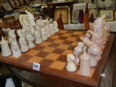 A stone chess set, (one piece repaired).