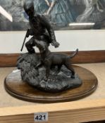 A bronze effect figure of a gamekeeper with dog.