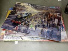 A quantity of old train puzzles glued onto card