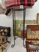 An iron framed mahogany top plant stand