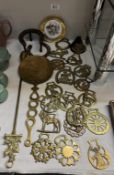 A quantity of horse brasses, horse shoe trivet, horse shoes etc