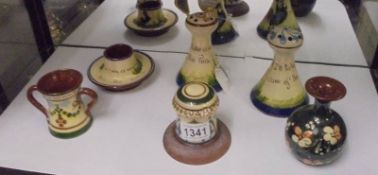 Six items of Torquay Mottoware including hat pin stands.