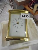 A modern battery brass carriage clock in working order.