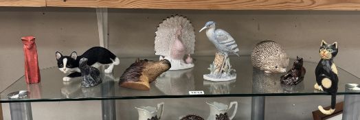 A quantity of animal ornaments including cats, horses, peacock etc