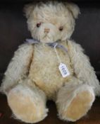 An old straw filled Teddy bear with growler.