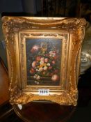A gilt framed study of flower arrangement.