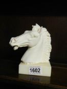 A signed horse head paperweight.