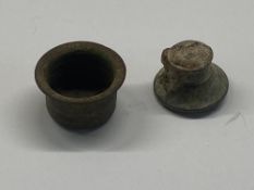 A medieval ink well with lid