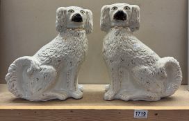 A pair of large Staffordshire pottery dogs