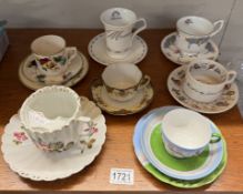 A large early 20th century moustache cup & saucer & 4 cups & saucers