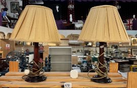 A pair of dark oak table lamps with shades