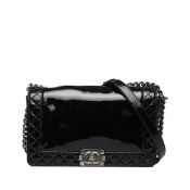Chanel Medium Patent Reverso Boy Flap The Boy Bag features a patent leather body, a chain-link