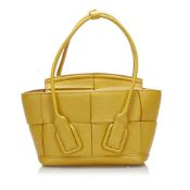 Bottega Veneta Intrecciato Mini Arco The Arco satchel features a leather body, rolled leather