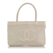 Chanel CC Canvas Tote This tote bag features a canvas body with leather trim, rolled leather