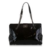 Chanel Patent Boy Reverso Shopping Tote This tote bag features a patent leather body, curb chain
