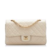 Chanel Medium Classic Lambskin Double Flap This shoulder bag features a quilted lambskin body, an