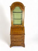 A small Continental oak and walnut domed top bureau cabinet