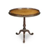 A late 19th century carved mahogany tripod table in the Chippendale style