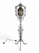 A vintage wrought iron standard lamp
