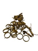 A quantity of early 20th century gilt brass and metal curtain pole rings