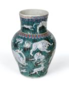 An Iznik green, blue and red glazed vase and two Turkish tiles