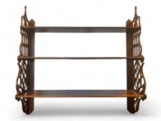 A Chippendale style mahogany three tier hanging shelf