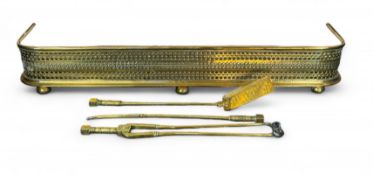 A Victorian brass fende, a set of brass firetools and two scuttles