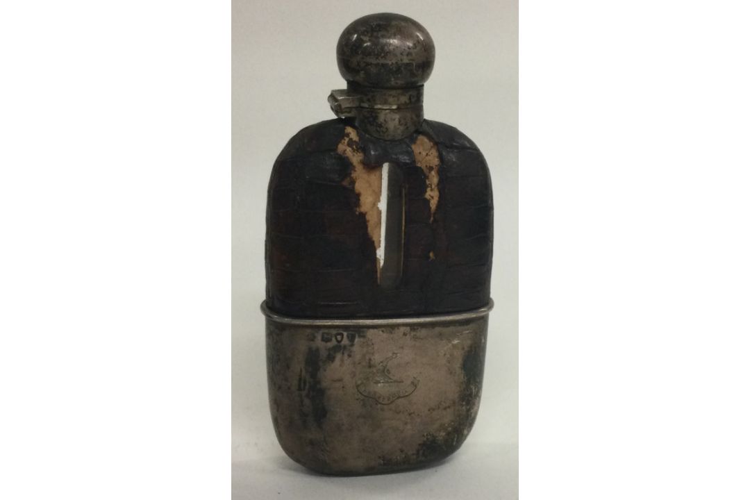 A Victorian silver flask with detachable silver cup. London 1895. By William Hutton & Sons.