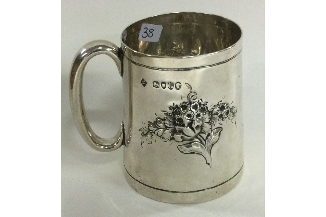 A novelty Victorian silver christening mug chased with flowers. London 1882. By Martin Hall & Co. - Image 1 of 2