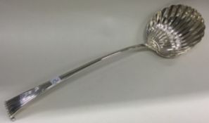 A large 18th Century silver Onslow pattern soup ladle of fluted design.