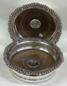 An oversized pair of Victorian silver wine coasters.