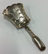 A George III silver bright-cut caddy spoon with pierced decoration.