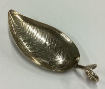 A George III silver bright-cut leaf shaped caddy spoon.