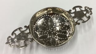 An 18th Century George II silver lemon strainer.