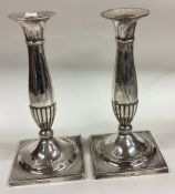 A good pair of 18th Century George III candlesticks on square bases.