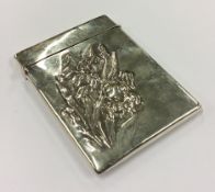 An early 20th Century American silver card case embossed with flowers.