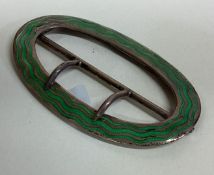 An Art Nouveau silver and green enamelled buckle.