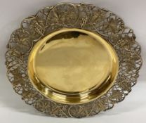A set of six pierced silver gilt plates with grape and vine decoration.