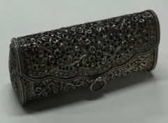A large pierced silver box in the form of a handbag.